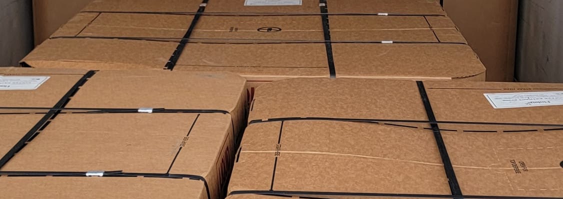 Large crates strapped to pallets, ready for full truckload shipping