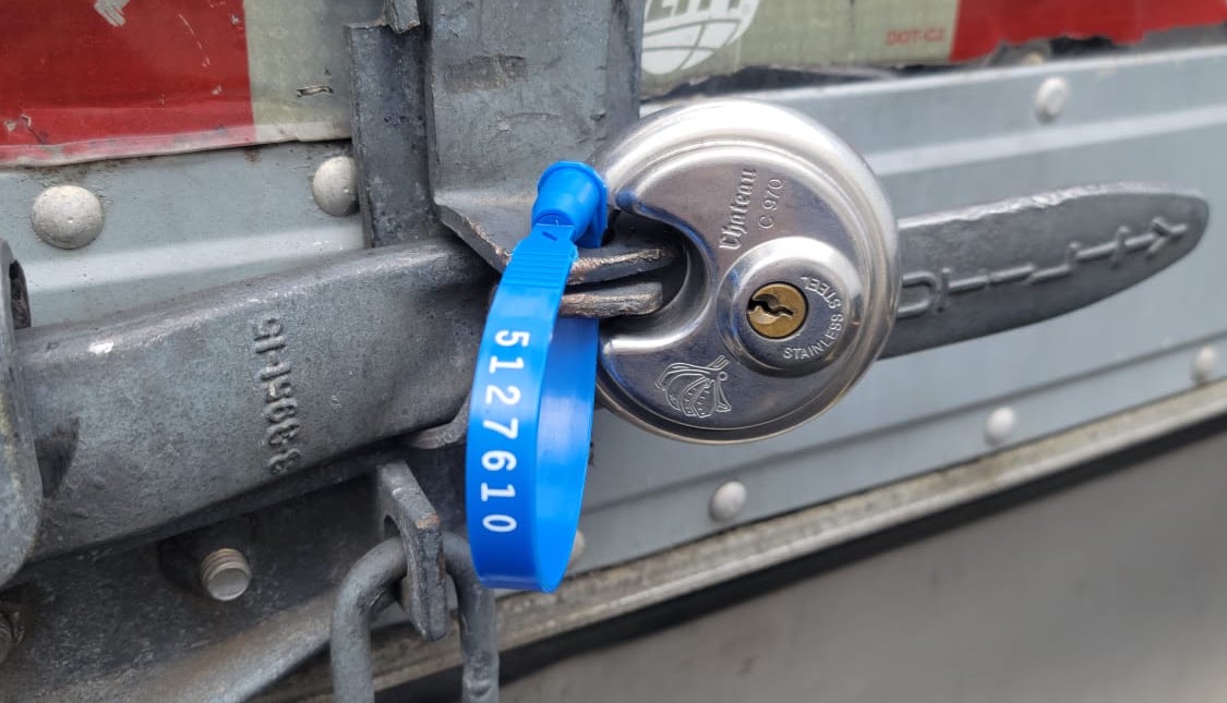 Numbered security seal and padlock fastened to an ELG trailer door